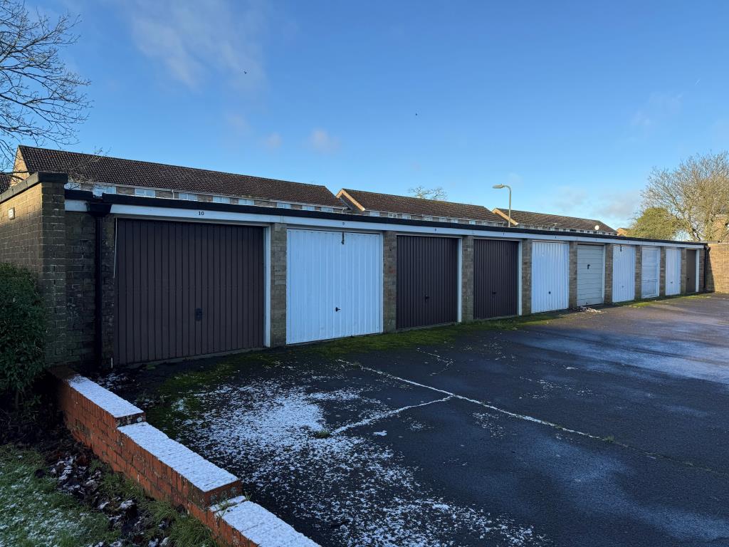 Lot: 46 - FIVE FREEHOLD GARAGES WHICH FORM PART OF A LARGER BLOCK - View of garages with up and over doors